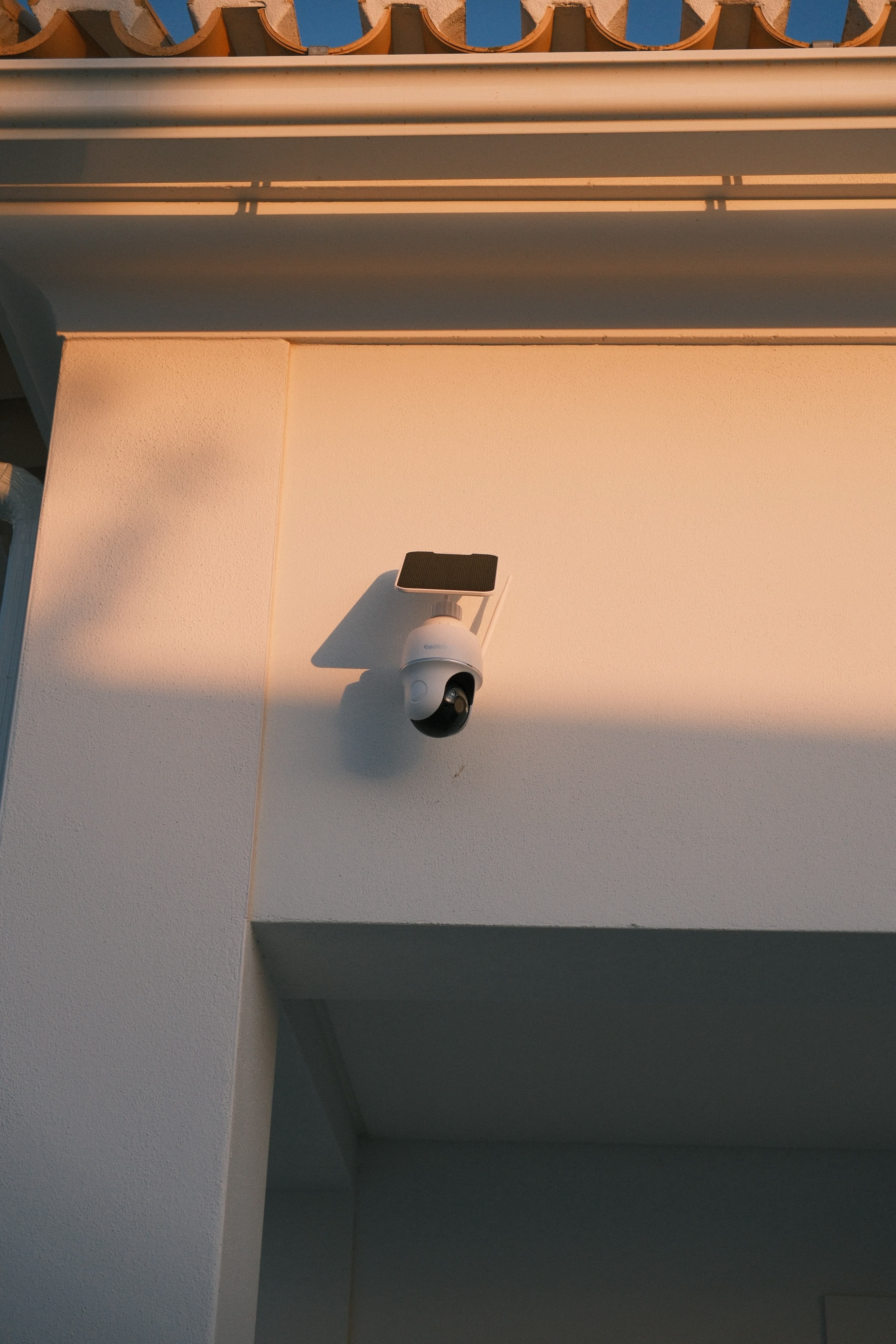 Close-up of an exterior camera integrated beneath the roofline