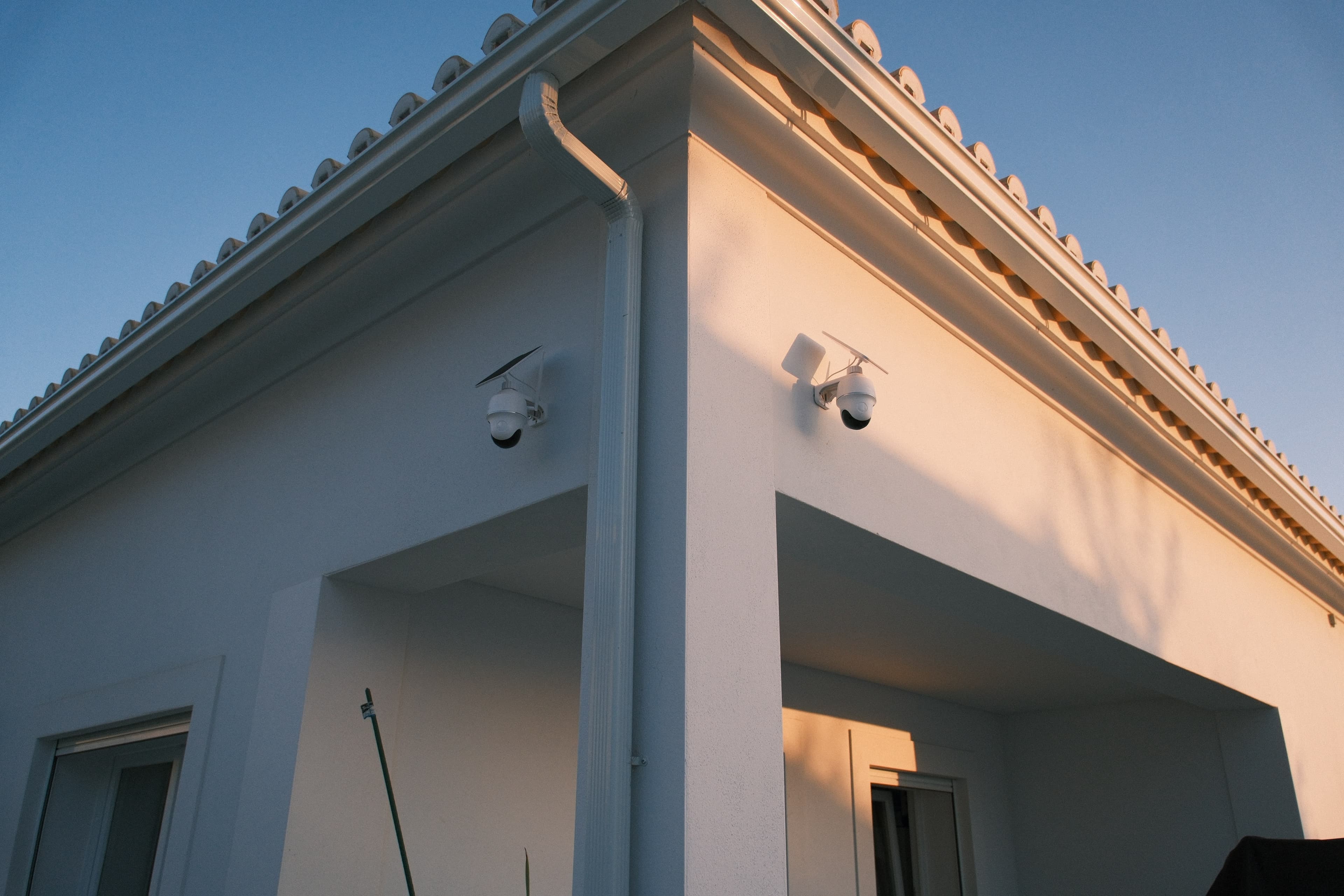 Exterior cameras integrated into a residential property's architecture